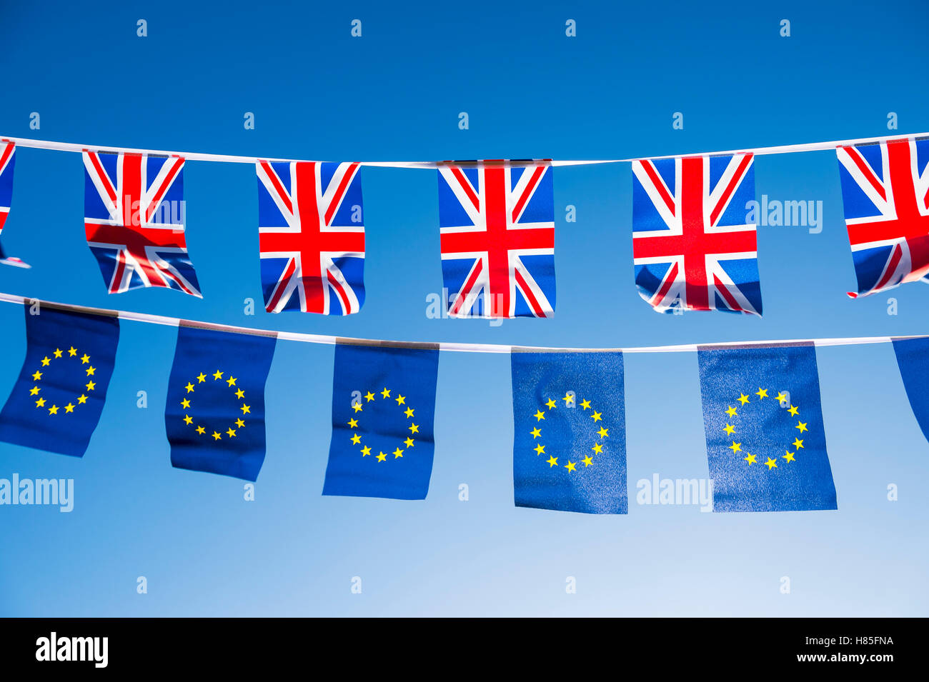 European Union and British Union Jack flag bunting flying in bright blue sky in a statement of the Brexit EU referendum Stock Photo