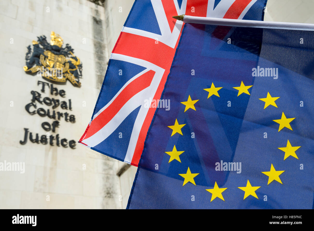 EU and Union Jack flags flying in front of The Royal Courts of Justice public building in London, UK Stock Photo