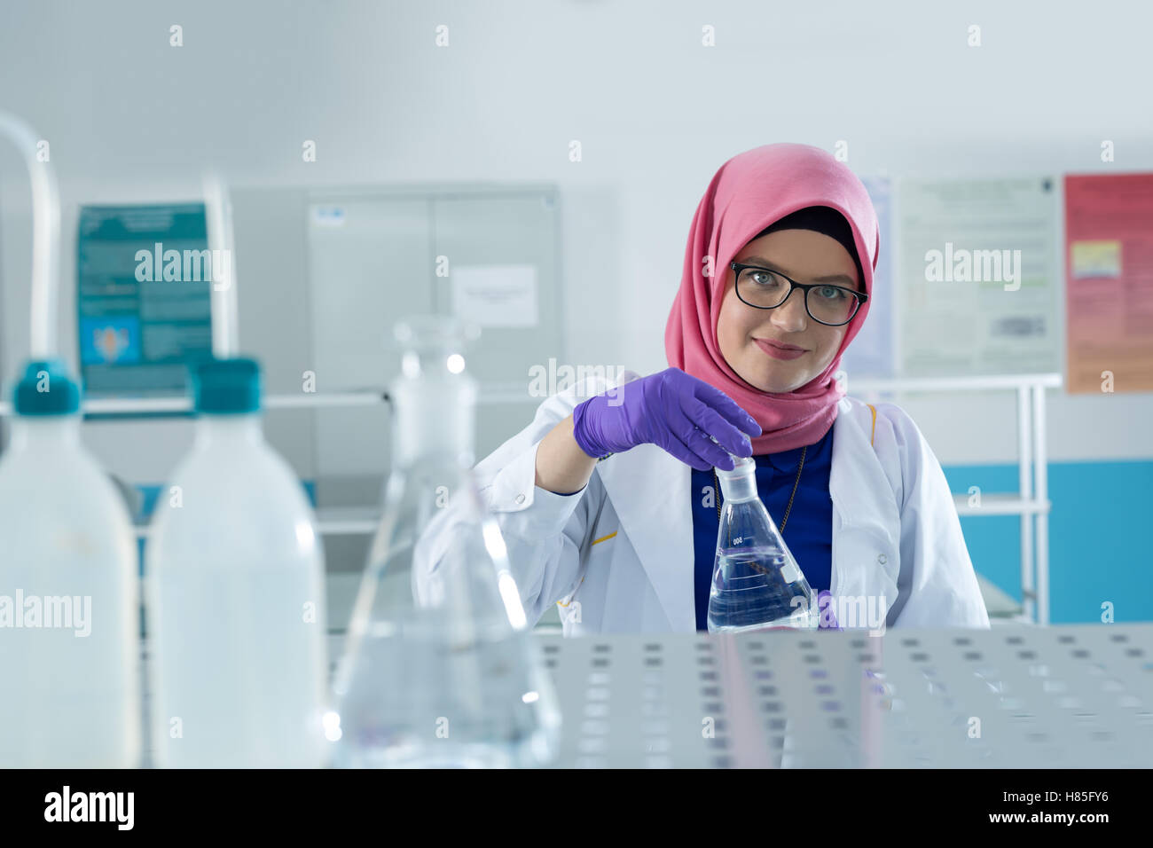 muslim lab worker with hijab or researcher doing an analysis in ...