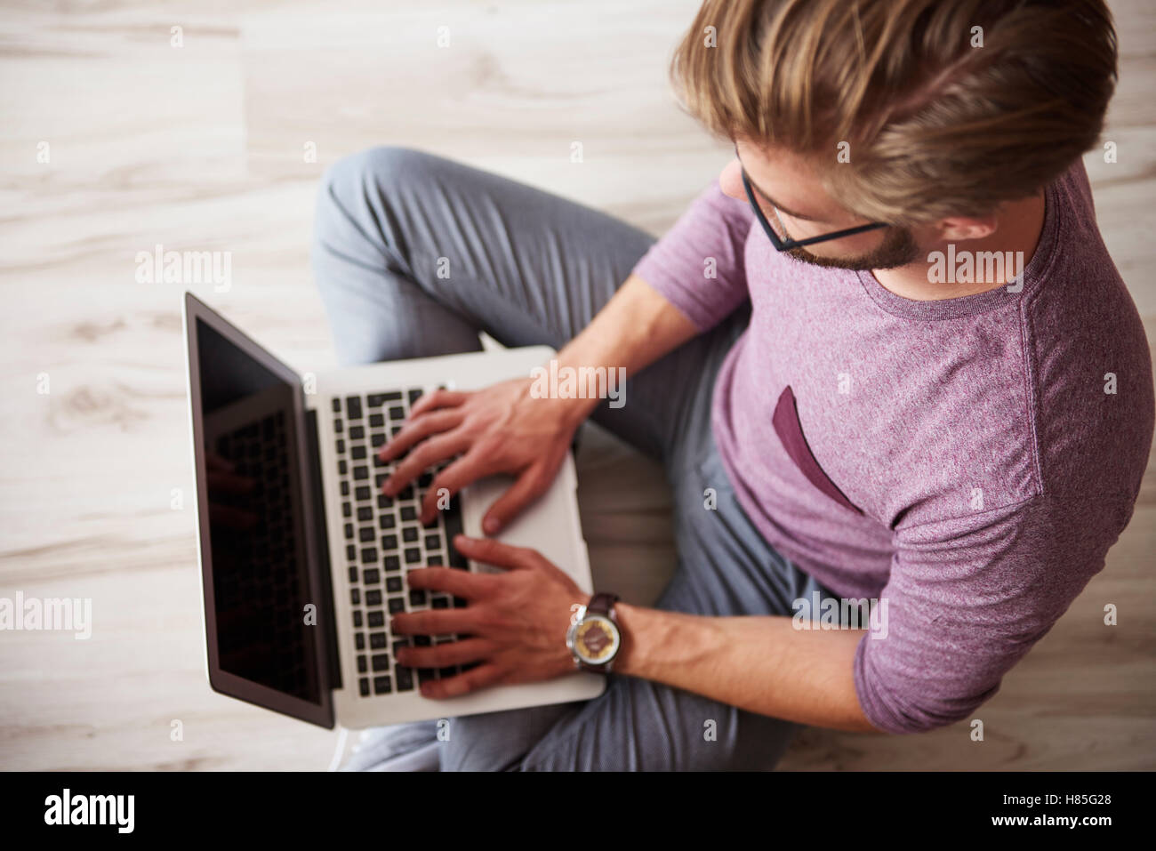 Man using the laptop on the floor Stock Photo Alamy