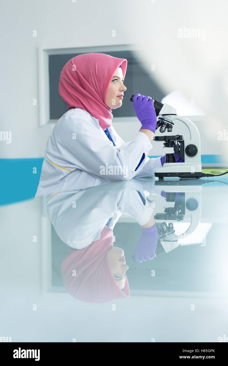 muslim lab worker with hijab or researcher doing an analysis in ...