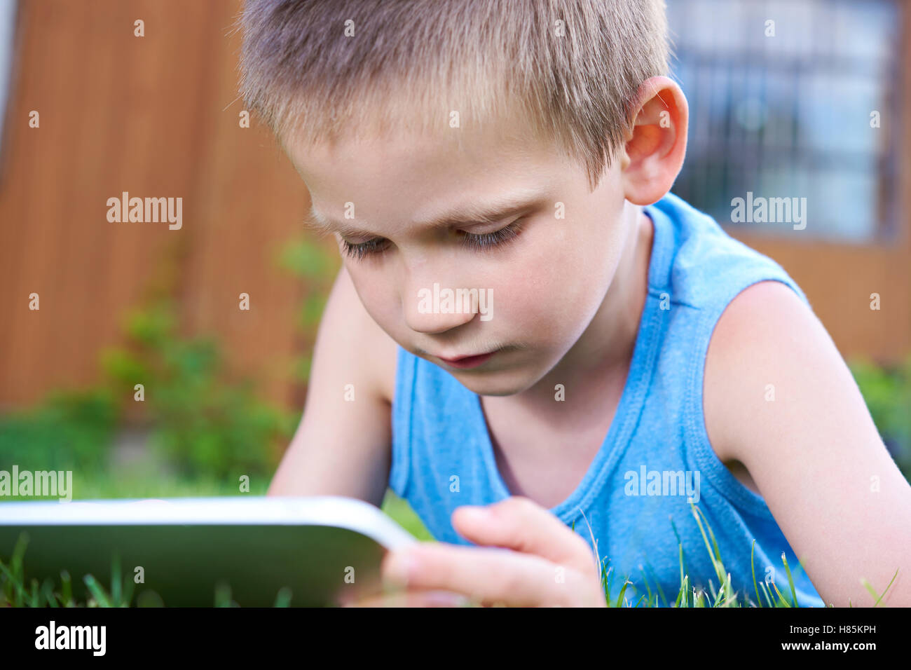 Little boy with tablet pc in summer day Stock Photo