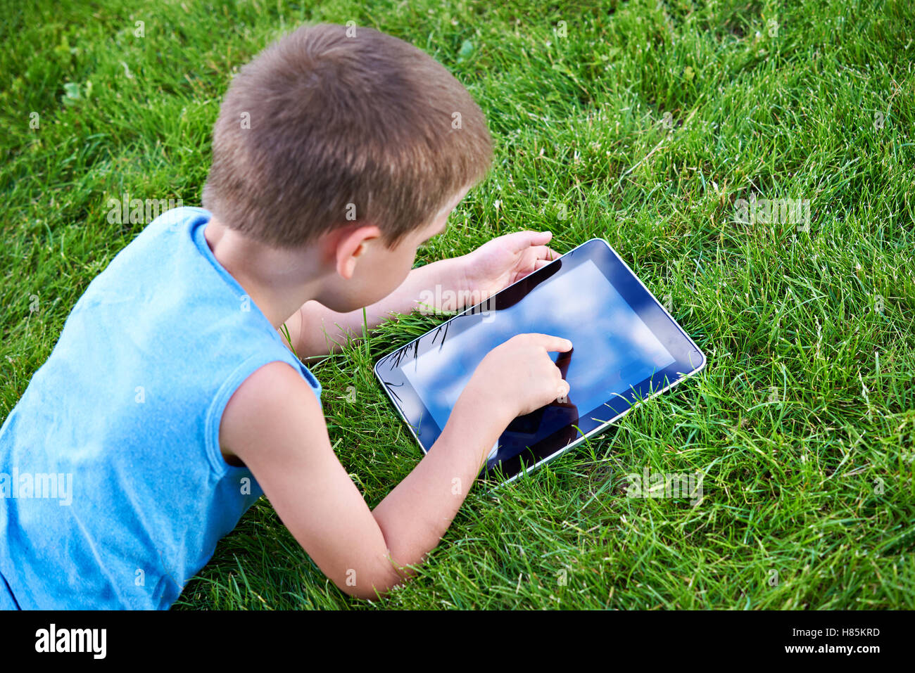 Little boy with tablet pc in summer day Stock Photo