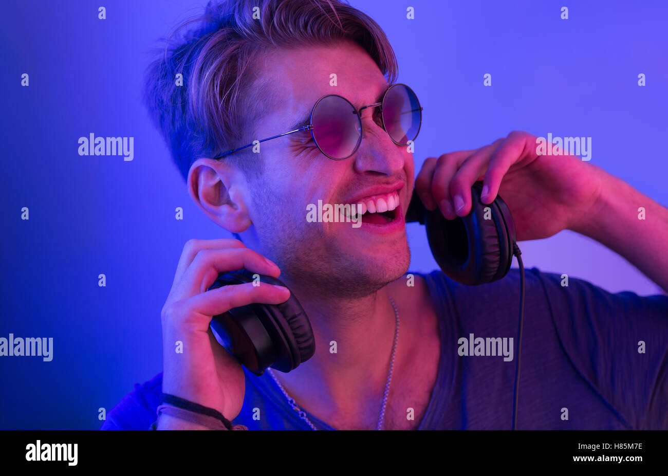dj with headphones in party scene, toned image Stock Photo