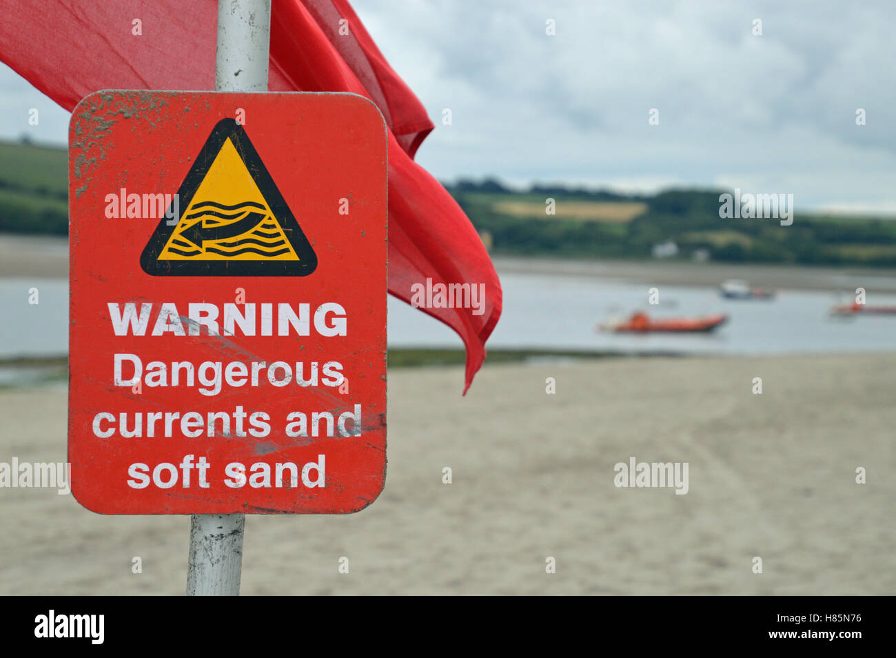 Warning sign on beach at Poppit Sands, Pembrokeshire, Wales Stock Photo