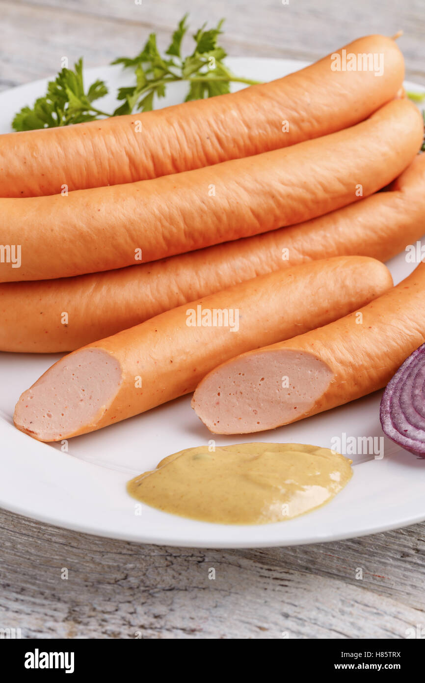Hot dog sausages with mustard on white plate Stock Photo