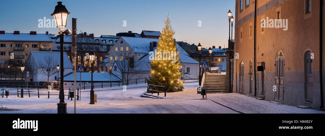 Christmas tree at the St Eriks torg at dawn with empty snowy streets in the central Uppsala, Sweden, Scandinavia Stock Photo