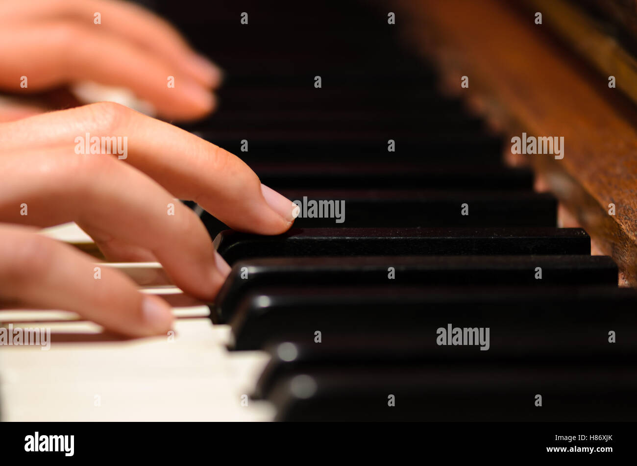 Playing piano, hands detail Stock Photo