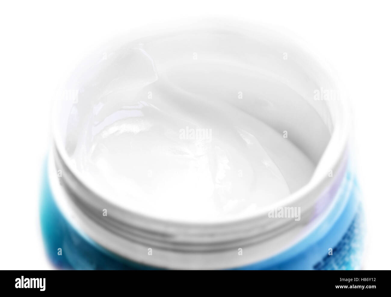 White face cream in blue jar closeup in white isolated background Stock Photo