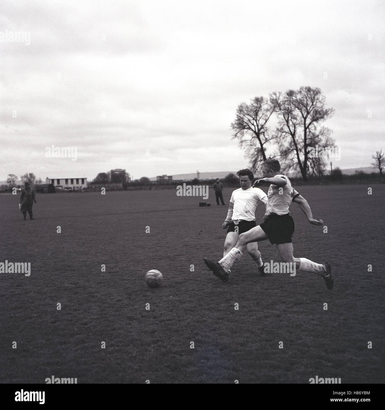 1965, historical, amateur football match, two male players competing for the ball, Bucks, England. Stock Photo