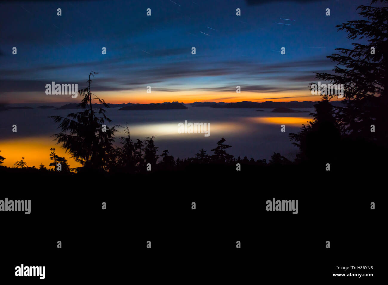 Lights from port and ships shining through ocean fog, Sitka, Alaska