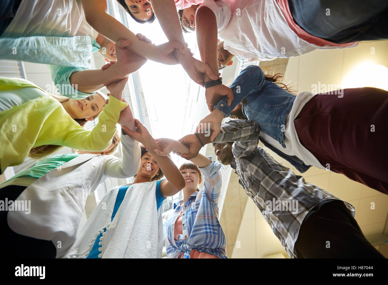 group of international students holding hands Stock Photo - Alamy