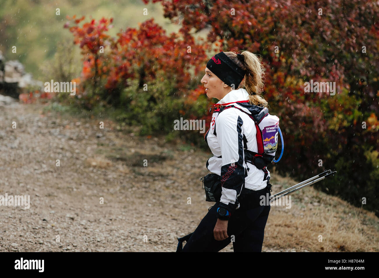 Closeup Young Runner Woman Running In Rain On A Mountain Trail