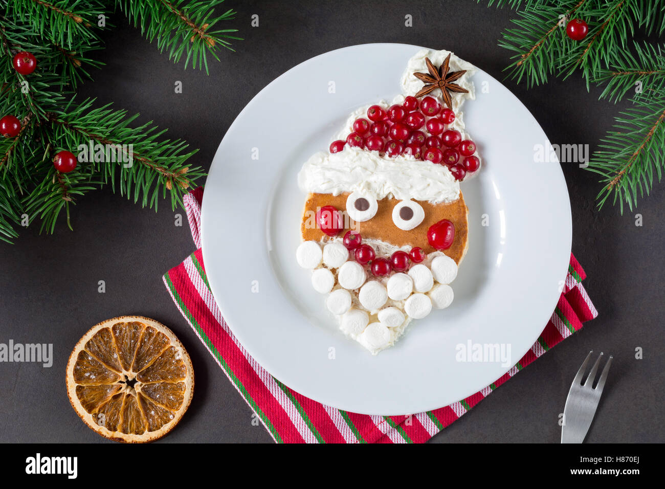 Creative breakfast for kids holiday. Pancake Santa, Christmas inspiration Stock Photo