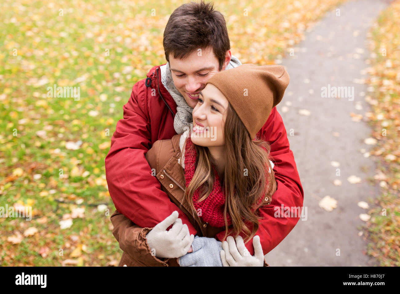happy young couple hugging in autumn park Stock Photo - Alamy