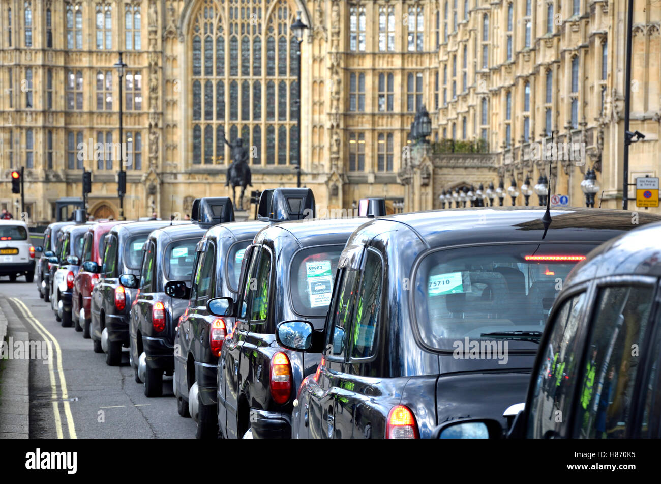 London, England, UK. A long queue of taxis outside Parliament during a protest against Uber, Feb 2016 Stock Photo