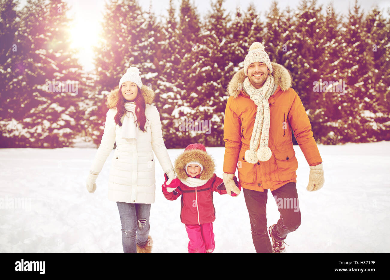 happy family in winter clothes walking outdoors Stock Photo - Alamy