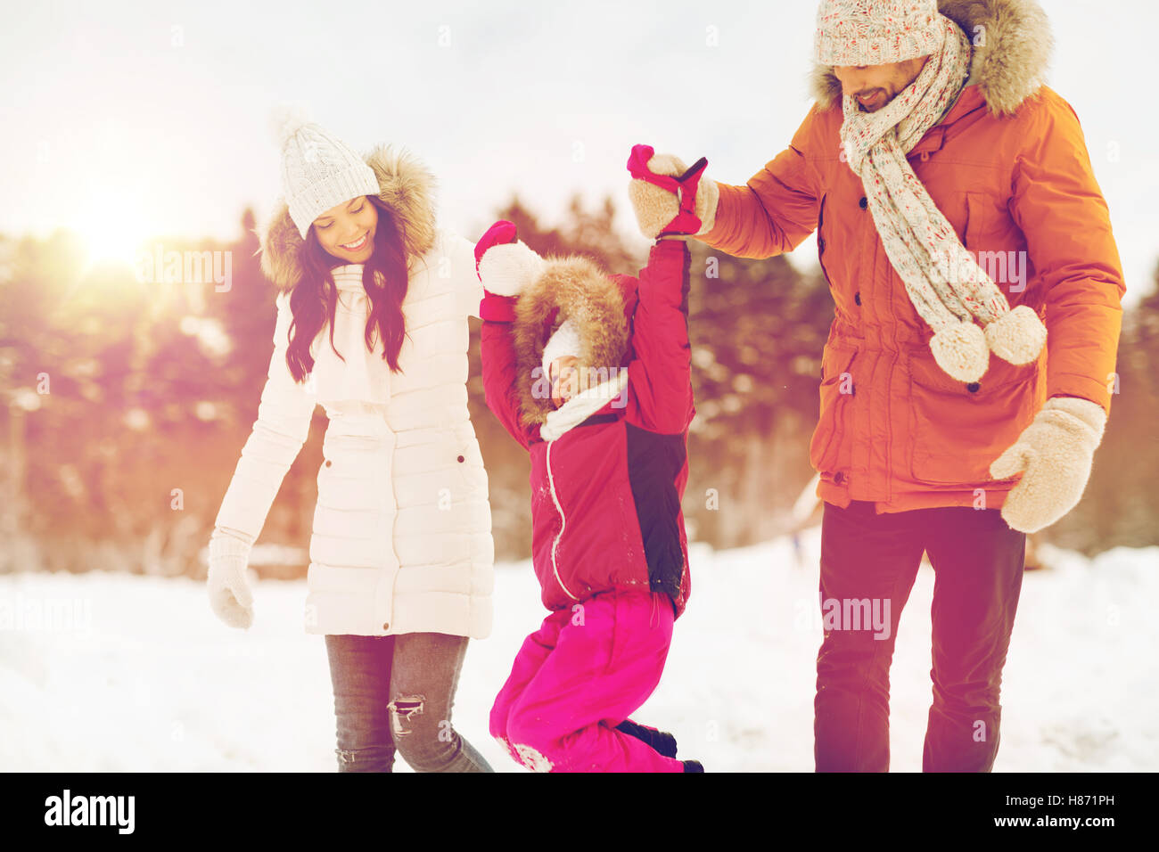 happy family in winter clothes walking outdoors Stock Photo - Alamy
