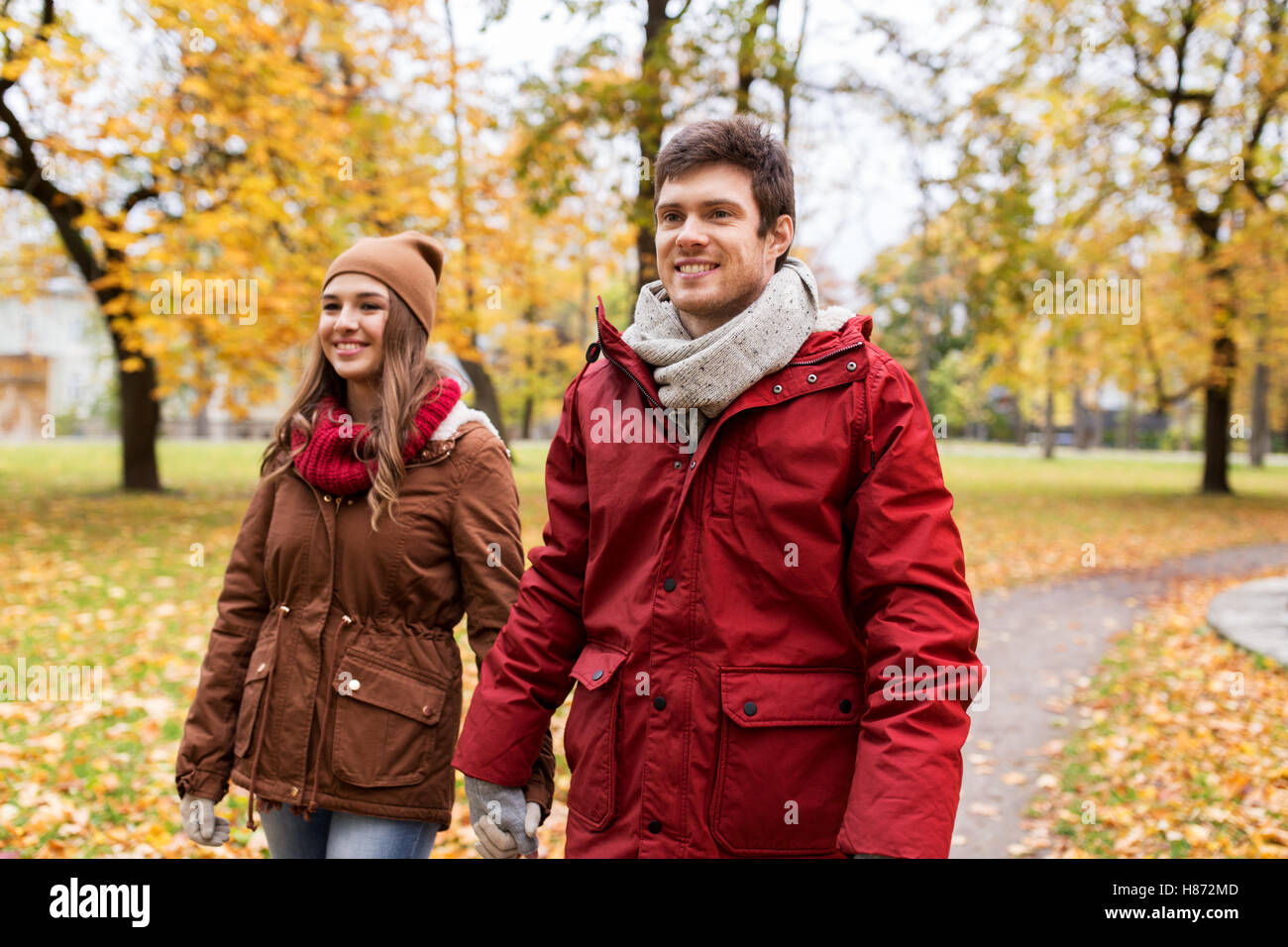 happy young couple walking in autumn park Stock Photo - Alamy