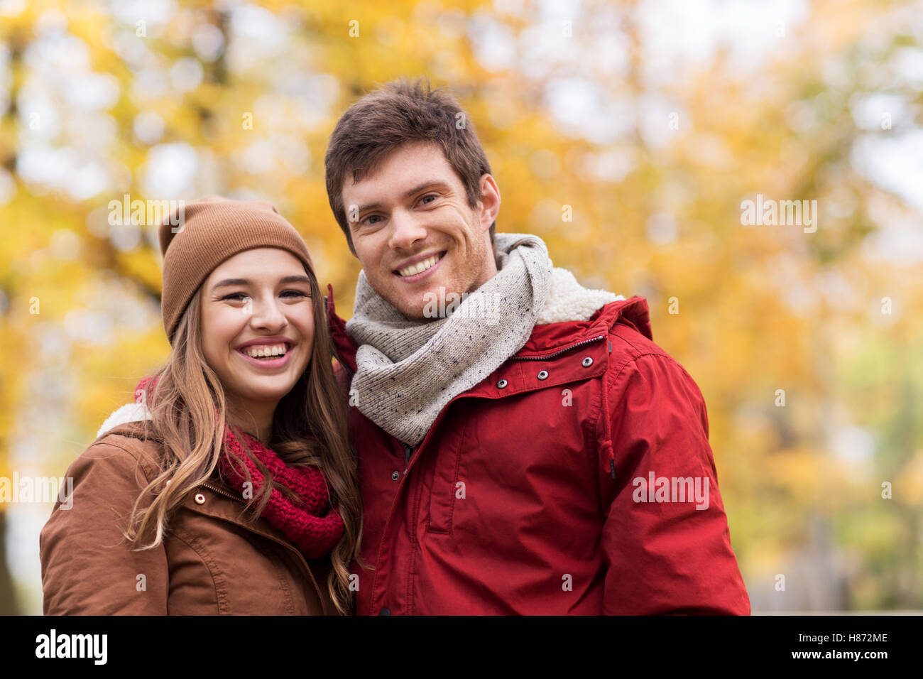 happy young couple walking in autumn park Stock Photo - Alamy