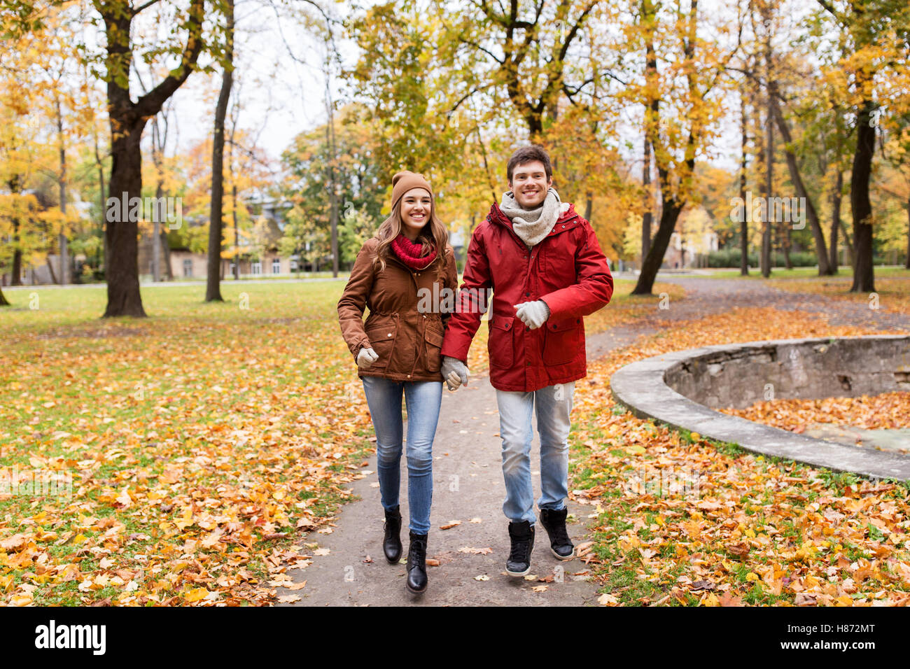 happy young couple running in autumn park Stock Photo - Alamy
