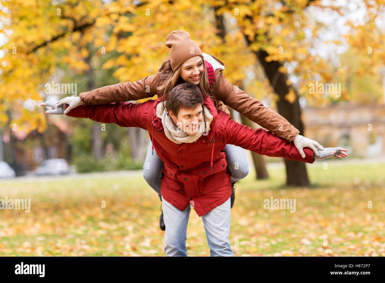 happy young couple having fun in autumn park Stock Photo - Alamy