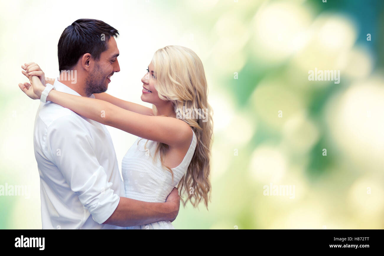 happy couple hugging over green background Stock Photo - Alamy