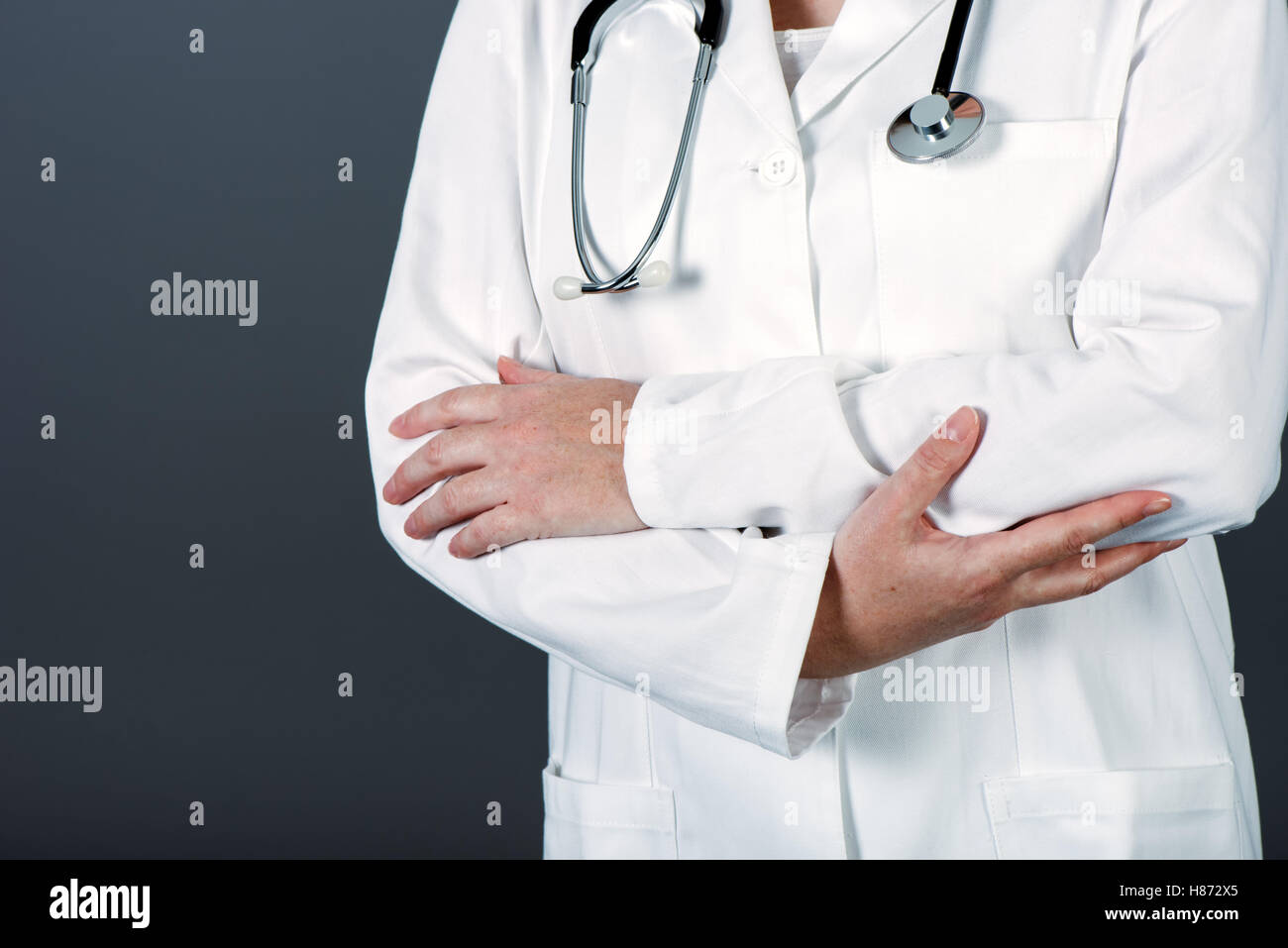 Unrecognizable female doctor posing confident in white medical uniform ...