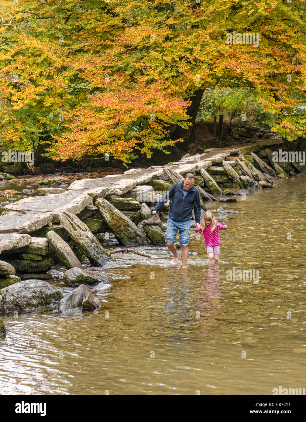 Autumn at Tarr Steps clapper bridge crossing the River Barle, Exmoor National Park, Somerset, England, UK Stock Photo
