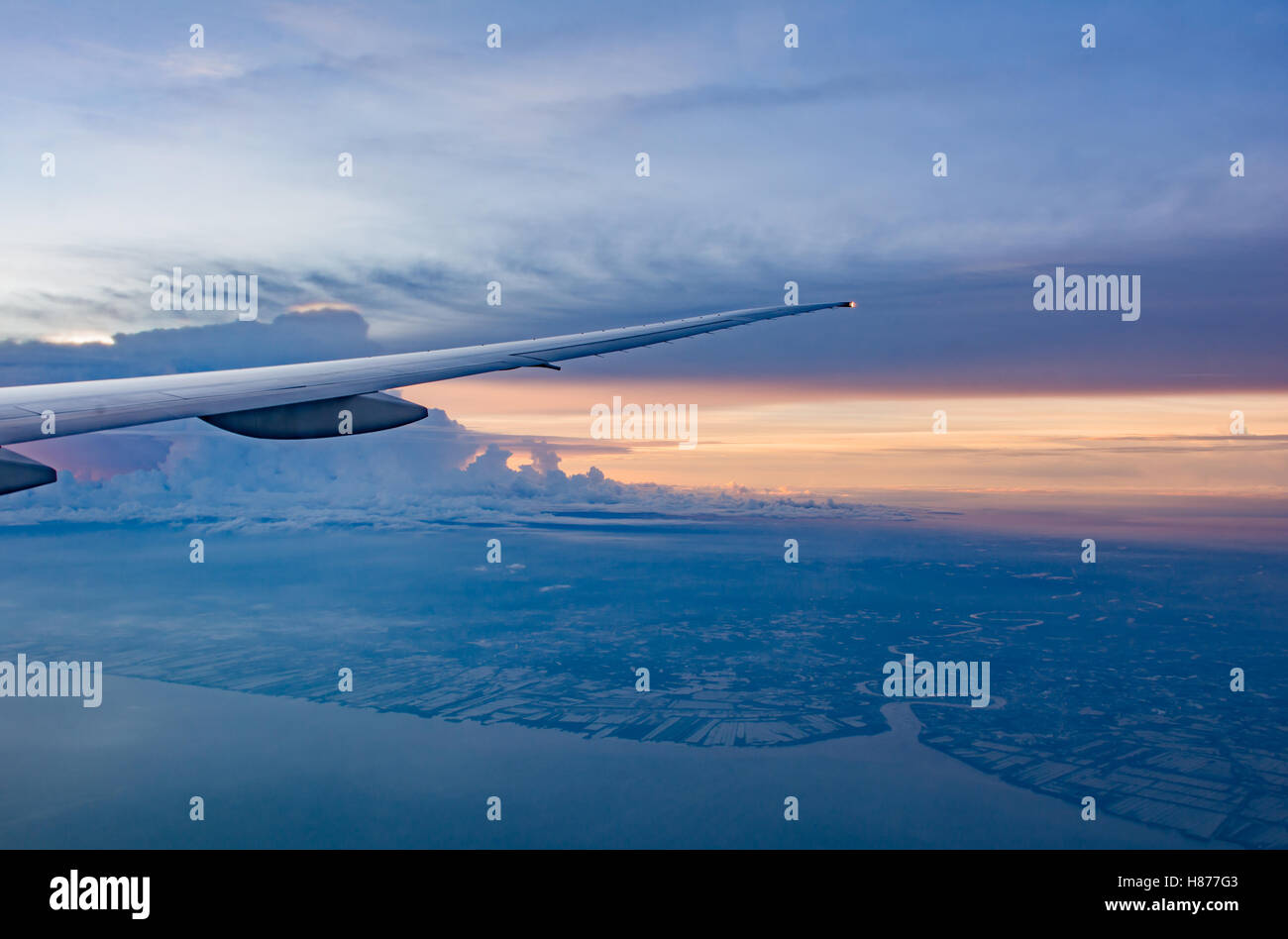 Looking from window to Air plane Wing in Flight , with beautiful scenery of sunset sky Stock Photo