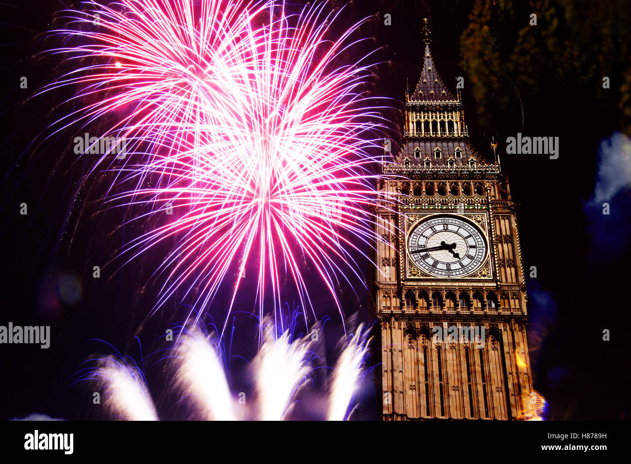 explosive fireworks display around Big Ben. New Year's Eve in the city - celebration background Stock Photo