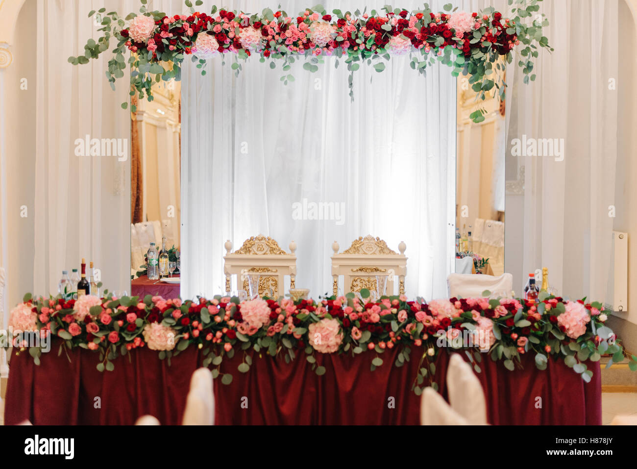 Festoons Table Rich dinner table decorated with red flower festoon Stock Photo - Alamy