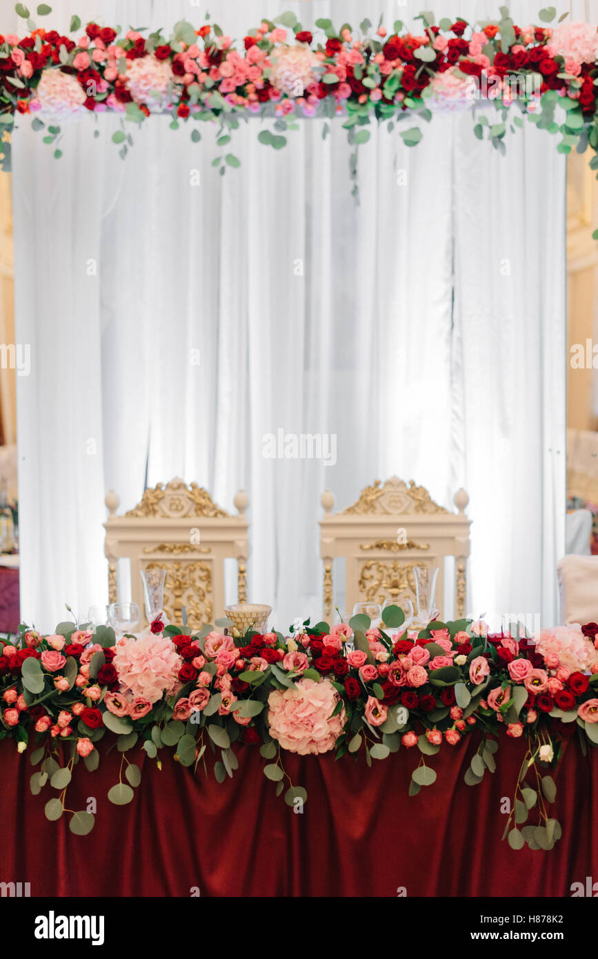 Festoons Table Rich dinner table decorated with red flower festoon Stock Photo - Alamy