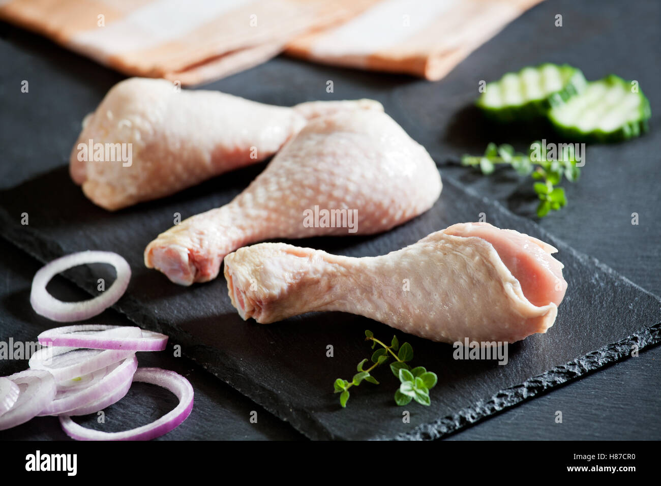 Three raw chicken drumsticks ready to be cooked Stock Photo - Alamy