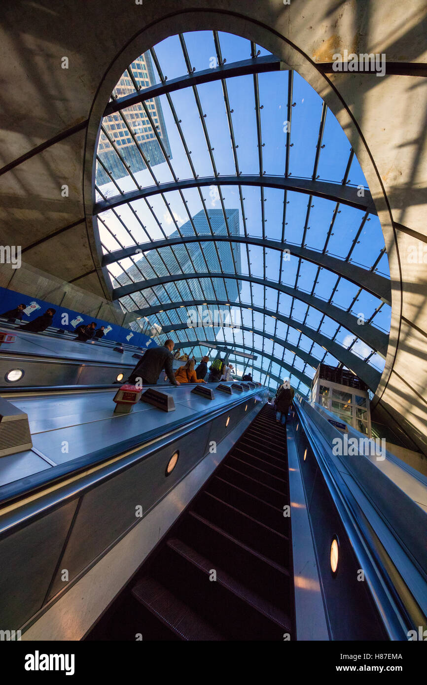 Escalators at the entrance to Canary Wharf tube station with glass domed roof London UK Stock Photo