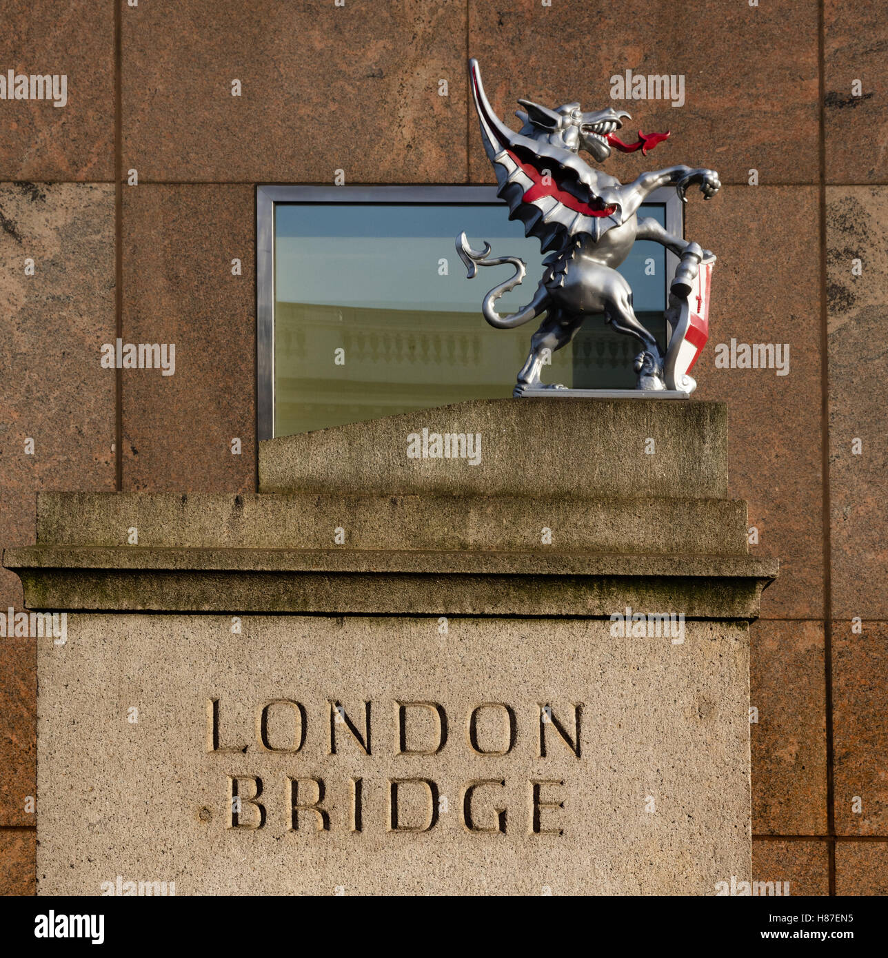 Gate on the road before London Bridge with pedestal and English dragon sculpture - London UK Stock Photo