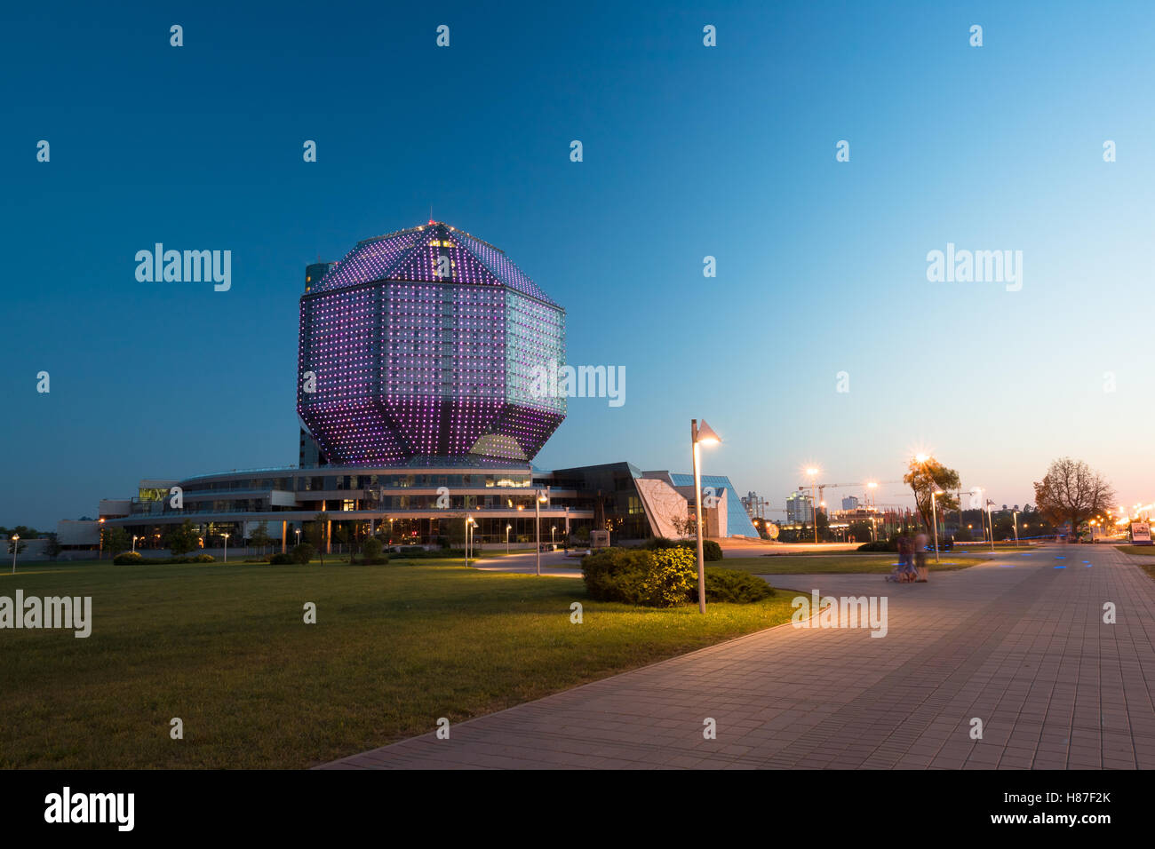 Minsk, Belarus. View Of Deserted Pedestrian Zone To National Library Building In Evening LED Illumination Blue Sky Background Stock Photo