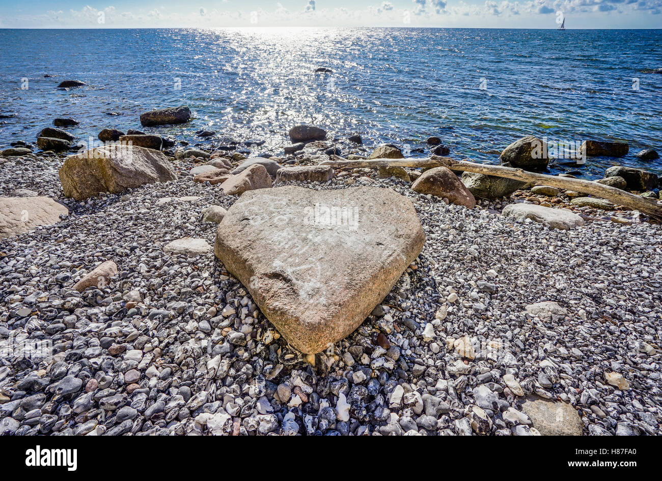 heart-shaped rock on the pebbly Baltic Sea beach below the famous Rügen chalk cliff at Jasmund National Park, Mecklenburg-Vorpom Stock Photo