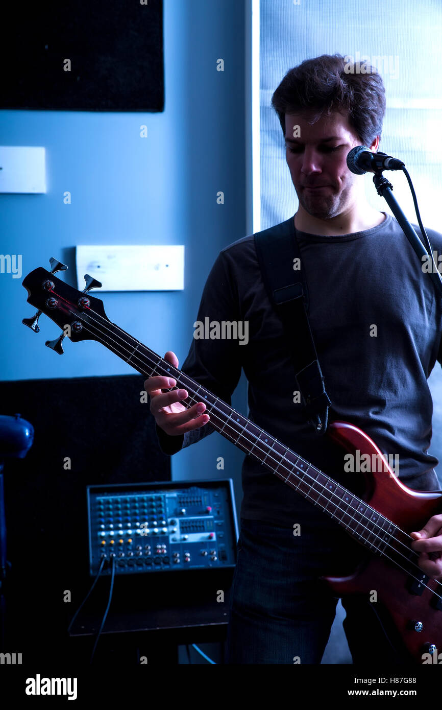 Black and white Portrait of a Rock singer playing bass in the rehearsal