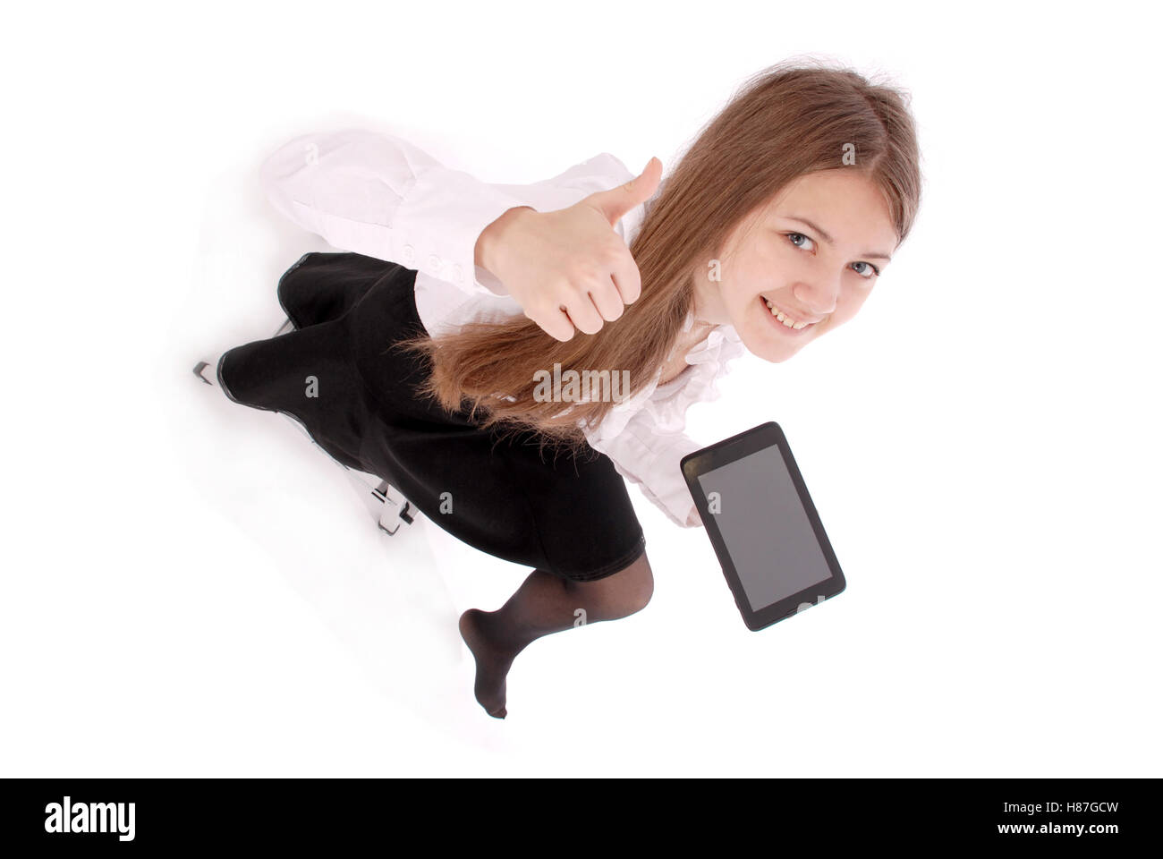 Beautiful young woman holding digital tablet sitting on a chair ...