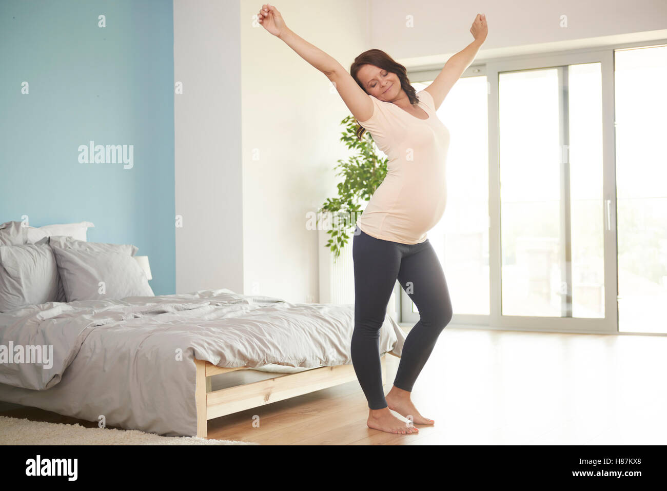Pregnant woman stretching after good night Stock Photo Alamy