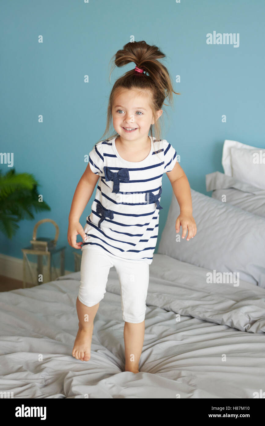 Little girl jumping on the bed Stock Photo Alamy