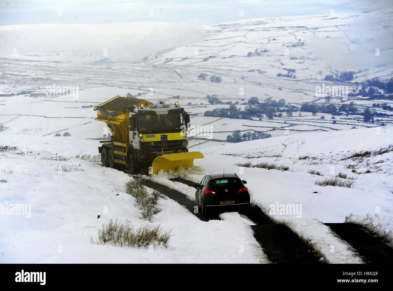 A snowplough clears a road over Grinton Moor near Reeth, as heavy overnight snowfalls across northern parts of the UK made travelling difficult. Stock Photo