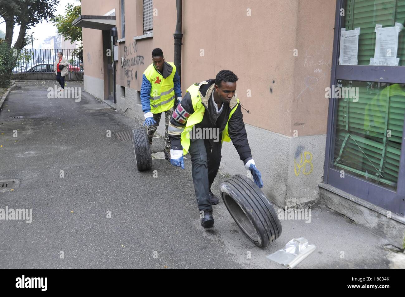 Milan, (Italy), a group of refugees and asylum seekers clean up abandoned cellars of popular houses as volunteer work Stock Photo