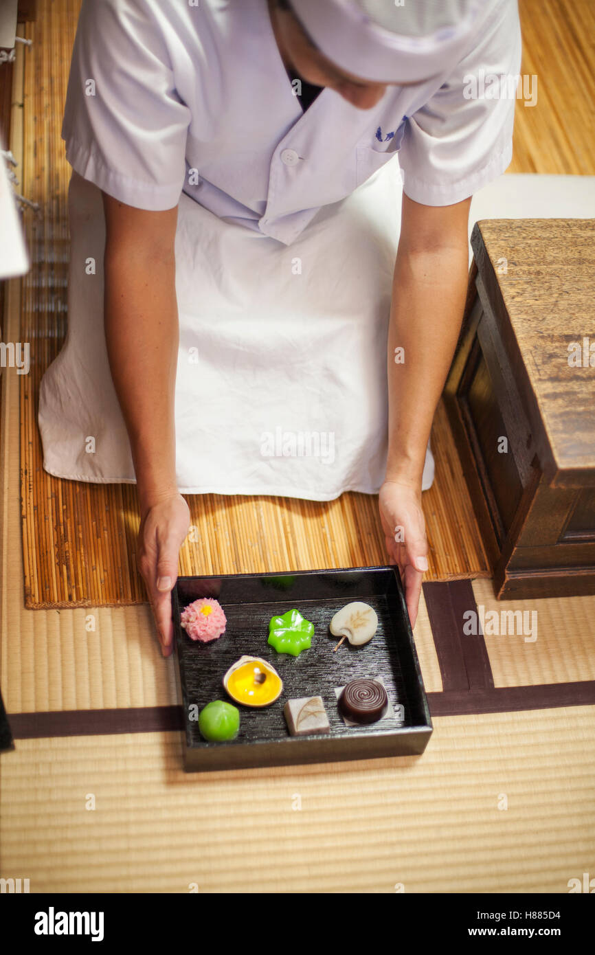 A small artisan producer of wagashi presenting a tray of selected wagashi of different shapes