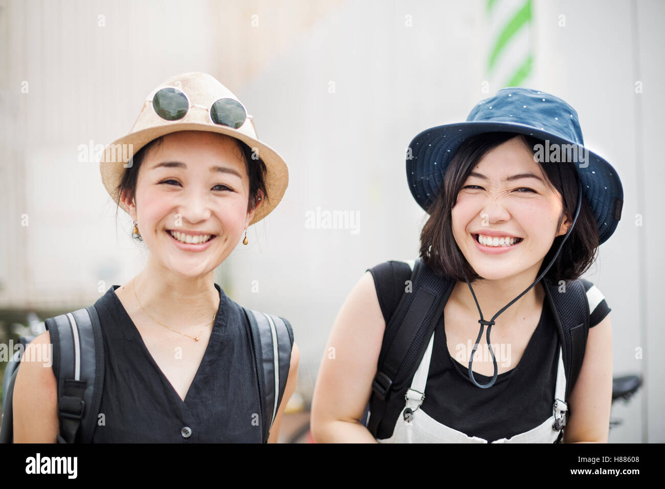 Portrait of two smiling young women wearing hats Stock Photo - Alamy