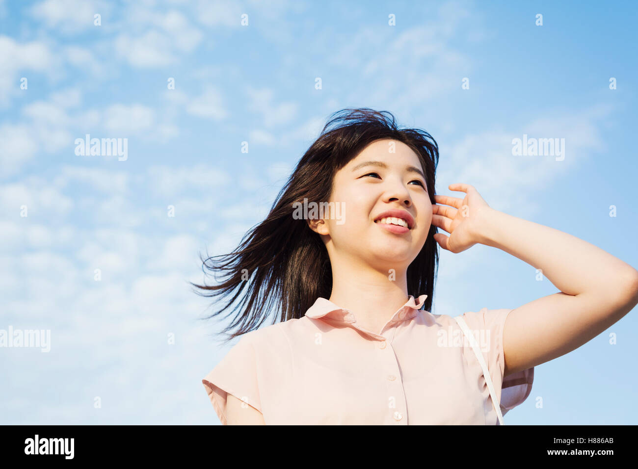 Portrait of a smiling young woman with long brown hair. Stock Photo