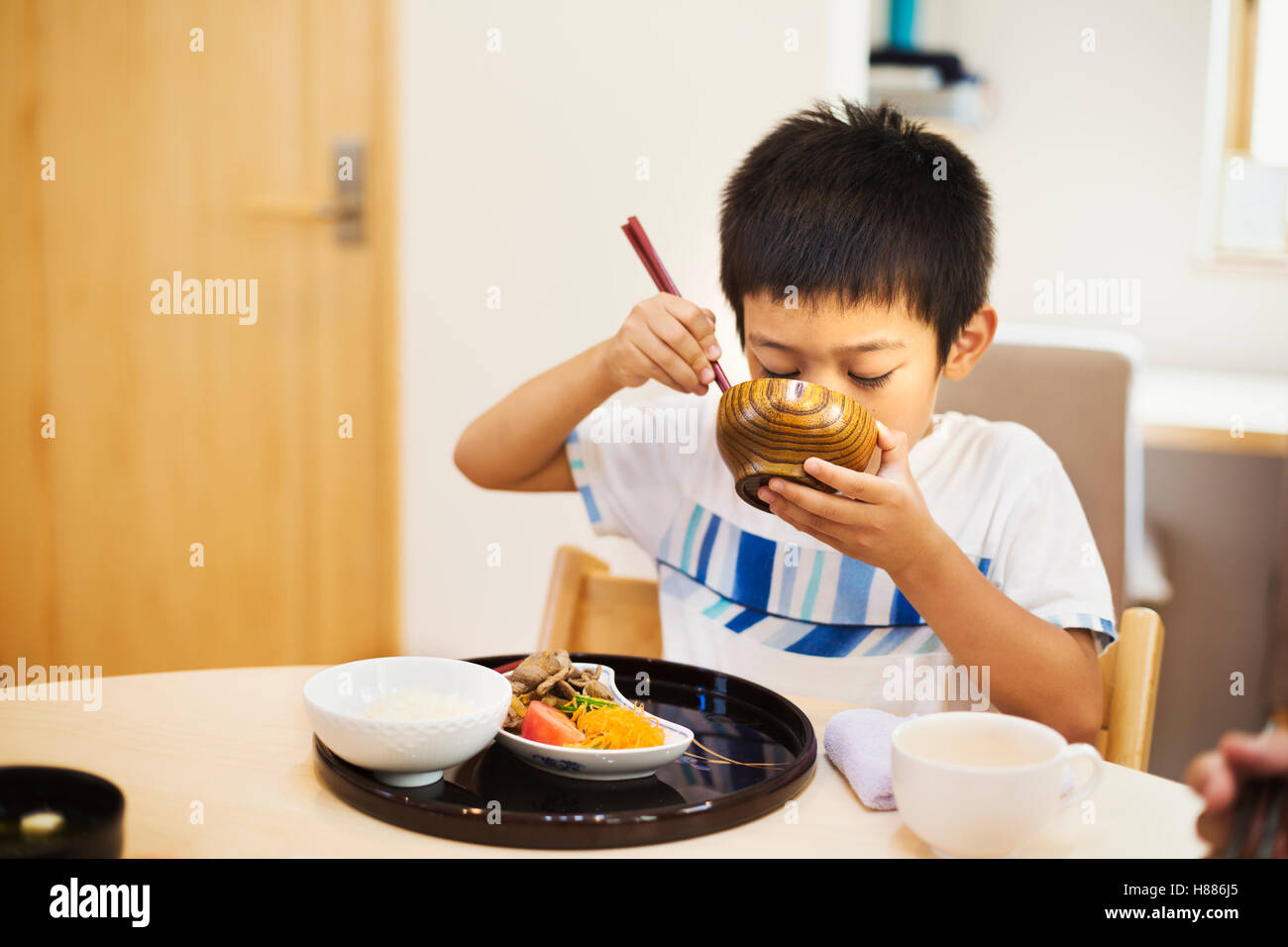 Family home. A boy eating a meal. Stock Photo