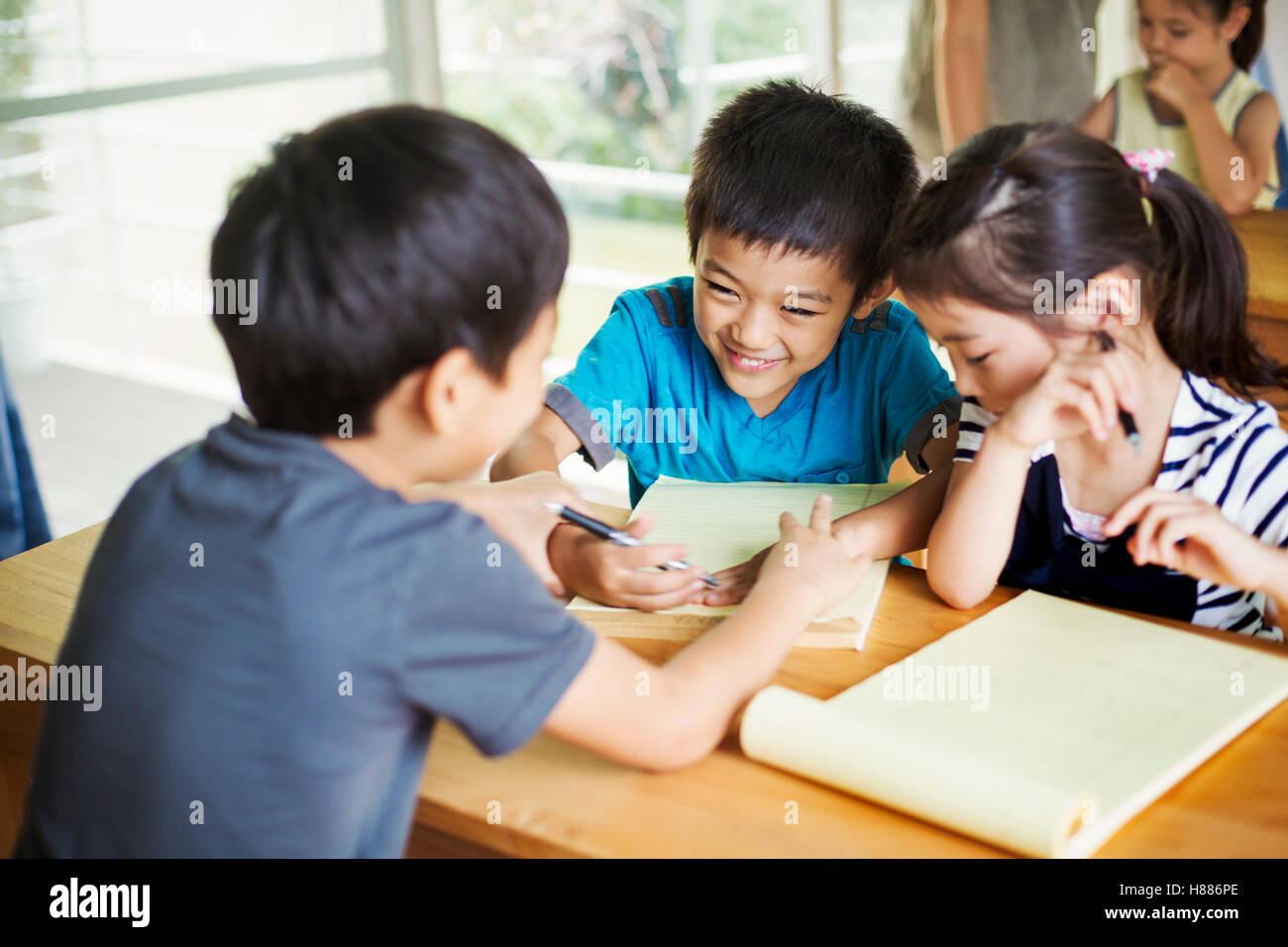 A group of children in a classroom, working together, boys and girls. Stock Photo