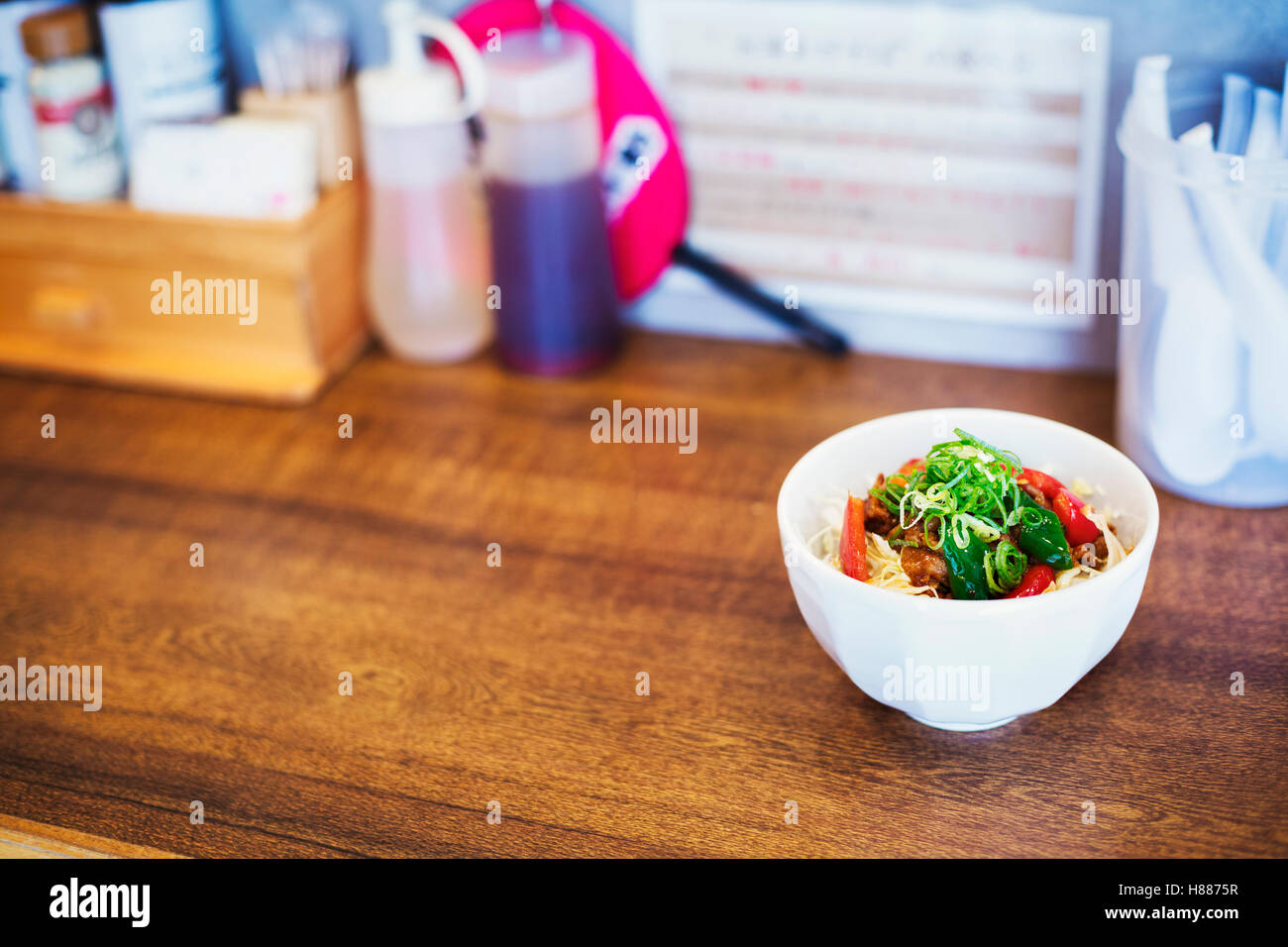 A ramen noodle shop. A bowl of fresh made ramen noodles with vegetables and meat. Stock Photo
